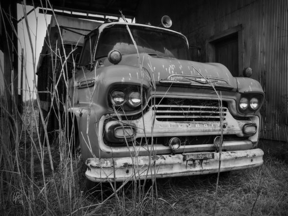 A vintage 1958 Chevy Spartan sits under the lean-to of an old cotton gin in Henning, TN.